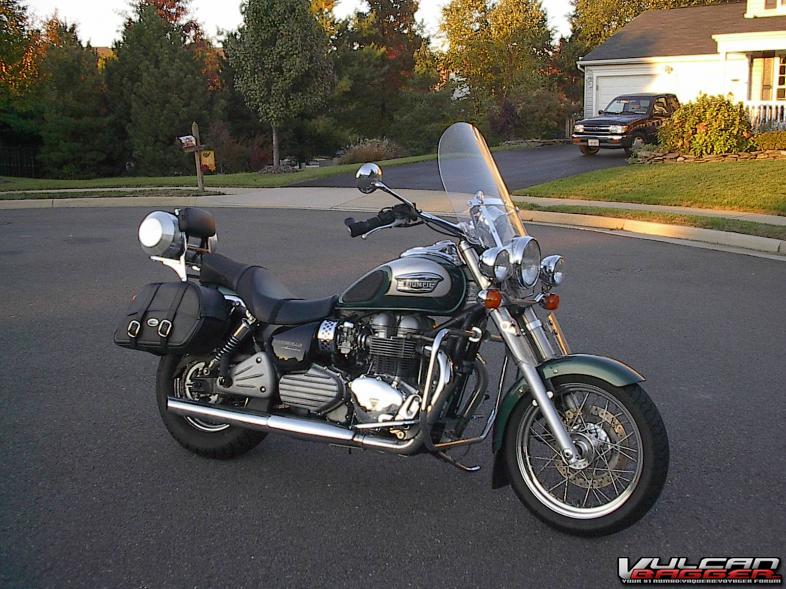 The 2004 Goodwood Green Triumph America that Triumph gave me for the 2003 Red. After spending 4 months of the first ownership year in the shop Triumph was pretty OK with swapping for a new one (and they gave me the floorboards, the screen, luggage rack, and sissy bar to keep me happy).  You'll notice the Tour Tank on the rear rack. Triumph was super comfortable but short on distance (150 miles or so, 2 hrs between gas stops). The 3.5 TT gave it longer legs. Triumph was traded for the 05 DR650 (real replacement was the Beemer).